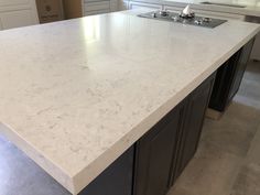 a kitchen counter top with an island in the middle