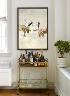 a painting hanging on the wall above a bar cart filled with liquor bottles and wine glasses