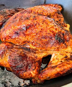 a cooked chicken sitting on top of a frying pan