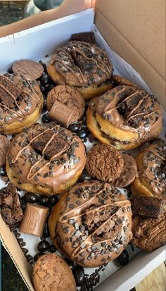 a box filled with lots of chocolate covered donuts