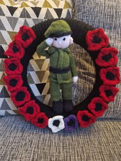 a knitted wreath with a toy soldier in the middle