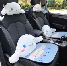 two stuffed animals sitting in the back seat of a car