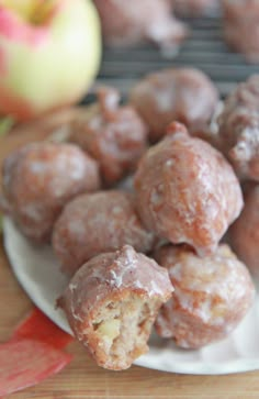 a plate full of donuts and apples on a table