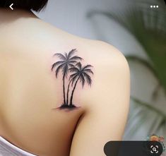 a woman's back with a small palm tree tattoo on it