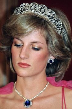 a woman wearing a tiara and earrings