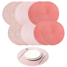 pink placemats and plates on white background with fork and knife next to each other