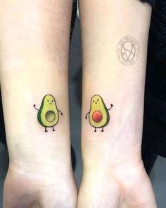 two small tattoos on both wrists with avocado and tomato