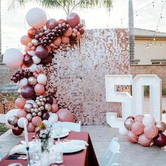 the table is set up with balloons and plates