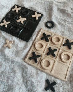 an assortment of toys like tic - tacs and doughnuts on a bed