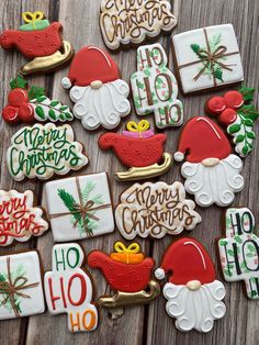 decorated christmas cookies on a wooden table with holiday sayings and decorations in the shape of santa's hats