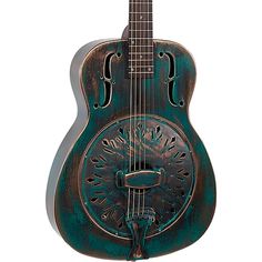 a green guitar with an intricate design on the back and sides, hanging from a wall