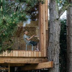 a man sitting in a chair on top of a tree house