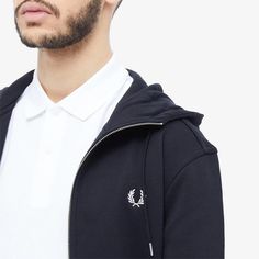 The Fred Perry Zip Hoodie is the casual essential for your Instagram feed. Featuring classic sportswear details like striped cuffs and embroidered laurel wreath that will elevate any #OOTD. Made from premium cotton blend with a drawstring hood and zip closure, it is supremely comfortable while still looking stylish. With its ribbed trims and split pouch pocket, this hoody is perfect for lazy weekends or travel days. With near 200 likes on your coffee post, boost your social status by adding this Sporty Cotton Track Jacket With Logo Detail, Sporty Cotton Hooded Jacket With Ribbed Cuffs, Sporty Hooded Sweatshirt With Ribbed Collar, Cotton Hooded Jacket With Ribbed Cuffs In Sportswear Style, Classic Hoodie Sweatshirt With Ribbed Cuffs, Classic Hoodie With Ribbed Cuffs, Classic Hooded Sweatshirt With Ribbed Cuffs, Casual Cotton Track Jacket With Embroidered Logo, Classic Sports Sweatshirt With Ribbed Cuffs