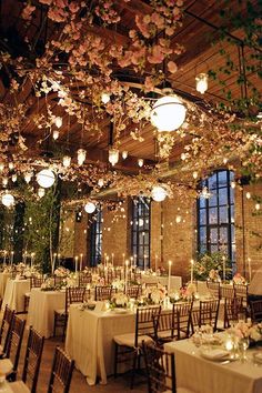 the tables are set with white tablecloths and centerpieces that look like flowers