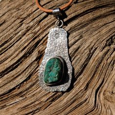 One of a kind! Custom shaped Sterling Silver pendant hand crafted high in the mountains of Northern New Mexico by local silversmith and lapidary artist Michael Silberhorn. Custom shaped Druzy Chrysocolla (Gem Silica) Cabochon set in custom made Sterling Silver setting. I hand form, hand texture and silversmith all the materials for a truly unique piece of art! This item is one of a kind - you will receive the exact item pictured. Chrysocolla is from the Inspiration Mine in Arizona. Approx. 40 mm Rustic Silver Oval Jewelry, Handmade Rustic Oval Jewelry, Artisan Untreated Oval Pendant Jewelry, Rustic Sterling Silver Pendant Jewelry, Rustic Silver Jewelry With Natural Stones, Silver Chrysocolla Cabochon Jewelry, Artisan Silver-toned Turquoise Cabochon Necklace, Artisan Silver Turquoise Necklace With Cabochon, Hand Forged Silver Turquoise Pendant Necklace