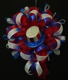 a red, white and blue wreath on a black background