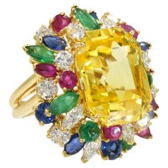 Oscar Heyman Yellow Sapphire, Colored Stone and Diamond Ring in 18k white gold. Center of the ring set with GIA certified emerald-cut yellow sapphire with total weight of 22.53ct. GIA report no. 1111180 stating that the yellow sapphire is of Ceylon origin, with no indication of heating. Surrounded by round, pear and marquise-shaped rubies with weight of approx. 2.30 carats, emeralds with weight of approx. 1.80 carats, sapphires with weight of approx. 1.75 carats and approx. 2.70 carats of diamon Luxury Multi-stone Yellow Sapphire Jewelry, Colored Stone, Sapphire Diamond Ring, Diamond Cluster Ring, Yellow Sapphire, Gems Jewelry, Gold Diamond Rings, Yellow Diamond, Diamond Cluster