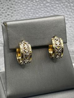 A gorgeous ladies pair of hoop earrings designed and crafted in 14 karat solid yellow and white gold.  The open scroll pattern adds dimension and unique beauty to this classic style.  They are perfect for any woman! Weight:  3.6 grams Diameter:  ⅝" Our Price $375.00 Regularly Priced At $600.00 Please See Our Video Remember - If you're purchasing for yourself or a gift for a loved one, buy with confidence.  We Guarantee Everything We Sell!  SKU # E789 Yellow Gold Elegant Hoop Earrings For Formal Occasions, Formal Yellow Gold Hoop Earrings With Elegant Design, Elegant Small Hoop Earrings With Intricate Design, Elegant White Gold Hoop Earrings Fine Jewelry, 14k Gold Earrings With Intricate Design For Anniversary, Yellow Gold Elegant Hoop Earrings, Elegant Small Hoop Filigree Earrings, Fine Jewelry Pierced Huggie Earrings For Anniversary, Elegant Filigree Hoop Earrings In 14k Gold