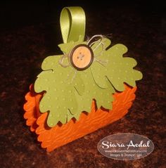 an ornament made to look like a carrot with a button in the center