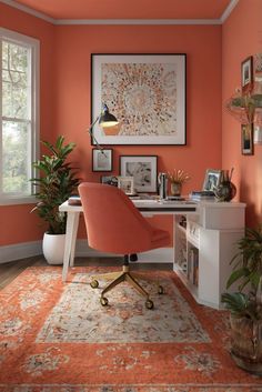 an orange chair sits in front of a desk with potted plants