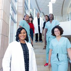 a group of doctors are walking down the stairs