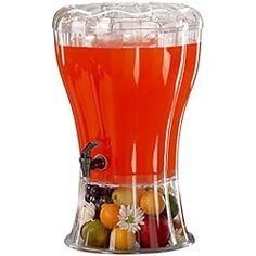 a drink dispenser filled with lots of fruit on top of a white background