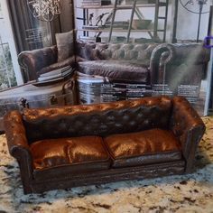 a brown leather couch sitting on top of a counter