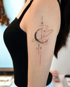 a woman's arm with a tattoo on it that has a crescent and stars