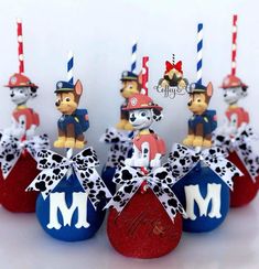 there are many small red and blue candys with dogs on them in the shape of firetrucks