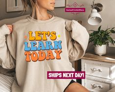 "Introducing our latest collection of Teacher Shirts and Sweatshirts! Whether you're a preschool teacher, an elementary school teacher, or a high school teacher, we have the perfect apparel to express your love for teaching and inspire your students. Check out our exciting designs and grab the ideal outfit for this back-to-school season! Gear up for an engaging classroom experience with our \"Let's Learn Today\" Teacher Shirt. This shirt is a perfect blend of comfort and style, allowing you to s Birthday Sweater, Flower Sweatshirt, Birth Month Flower, Floral Sweater, Birth Month Flowers, Plant Mom, Flower Shirt, Birth Flower, Birth Month