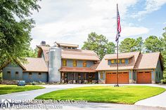 a large house with an american flag flying in the front yard