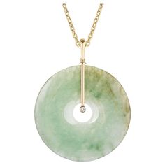 Jade Donut Pendant with Diamonds in 18k Yellow Gold, from 'G-One' Collection Stone size: 50 mm Diamond: G-H / VS, Approx Wt: 0.10 Carats Luxury Polished Finish Jewelry With Round Stone, Luxury Polished Round Stone Jewelry, Jade White Gold Necklace, Luxury Jade Fine Jewelry Necklace, Luxury Jade Pendant Necklace, Luxury Modern Jade Jewelry, Luxury Jade Necklaces For Meditation, Luxury Round Stone Work Jewelry, Contemporary Jade Jewelry