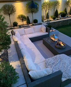 an outdoor living area with couches and tables