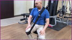 a man sitting on top of a chair in a gym holding his leg up to the ground