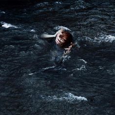 a woman is swimming in the water