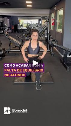 a woman sitting on top of a bench in a gym