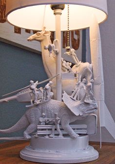 a lamp that has some figurines on it