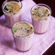 three glasses filled with food sitting on top of a white napkin next to each other