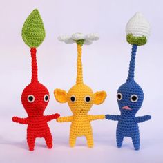 three crocheted toys are standing next to each other