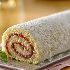 a rolled up cake sitting on top of a metal tray