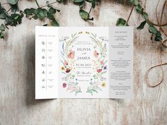 an open wedding program with flowers and greenery