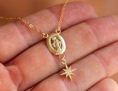 "This is a very sweet Miraculous medal charm necklace with pave crystal star. Such a simple yet lovely little necklace she is sure to love! Mother Mary medallion is 14kt yellow gold filled, measures 15x10mm and comes on a 14kt yellow gold filled shiny cable chain. Star charm is gold plated and measures 10mm. Necklace may be ordered in a 15\" choker, 16\", 18\", 20 or 22\" length. Necklace comes with a spring clasp in back. Also available in sterling silver or rose gold filled. Model is wearing a Catholic Jewelry Necklace, 14kt Gold Jewelry, Clean Sterling Silver, Catholic Jewelry, Turquoise Crystal, Confirmation Gifts, Gold Heart Necklace, Bridesmaid Bracelet, Miraculous Medal