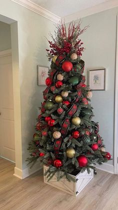 a christmas tree decorated with red, gold and green ornaments