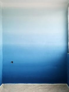 an empty room painted in blue and white