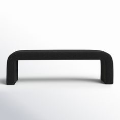 a black bench sitting on top of a white floor