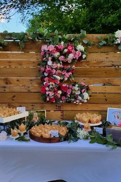 a table topped with lots of desserts covered in flowers