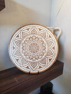 a wooden plate sitting on top of a shelf