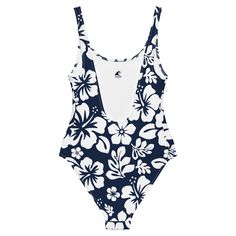 Live your best beach life in our White Hawaiian Flowers on Navy Blue One-Piece Swimsuit. With a beautiful floral print and flattering fit, this swimsuit is perfect for all shapes and sizes. The silky smooth material will have you feeling the Aloha love while you chill at the beach or pool. Now that's something to be Extremely Stoked about!• 82% Polyester, 18% Spandex• Chlorine-resistant fabric• Cheeky fit with a scoop neckline and a low scoop back• Zig-zag stitching• Double-layer front• Four-way Spring Tropical Print Swimwear For Surfing, Printed Beachwear For Surfing, Printed Swimwear For Surfing, Printed Tankini For Surfing Beachwear, Floral Print Surfing Swimwear Beachwear, Beachy One-piece Printed Bodysuit, Beachwear Swimwear With Floral Print For Surfing, Floral Print Beachy Swimwear For Surfing, Beachy Floral Print Swimwear For Surfing