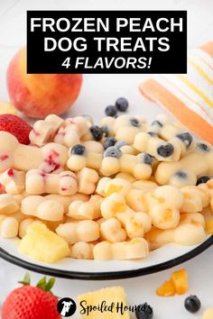 frozen peach dog treats with blueberries and strawberries on the side in a bowl