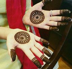 two women with henna tattoos on their hands